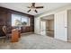 Bedroom with wood paneled walls, carpet, ceiling fan, and view of exterior scenery at 750 S Alton Way # 4B, Denver, CO 80247