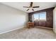 Bedroom with wood paneled walls, carpet, ceiling fan, and view of exterior scenery at 750 S Alton Way # 4B, Denver, CO 80247