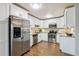 Bright kitchen featuring stainless steel appliances, granite countertops, and white cabinets at 750 S Alton Way # 4B, Denver, CO 80247