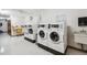Bright laundry room featuring multiple, modern washers and dryers for tenant convenience at 750 S Alton Way # 4B, Denver, CO 80247