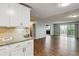 The living area has wood flooring and a balcony, with a kitchen featuring granite countertops nearby at 750 S Alton Way # 4B, Denver, CO 80247