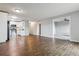 Open-concept living area with wood floors leading into an adjacent room with carpet at 750 S Alton Way # 4B, Denver, CO 80247