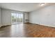 Spacious living room featuring hardwood floors and access to a balcony at 750 S Alton Way # 4B, Denver, CO 80247