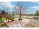 Landscaped backyard with a central tree feature and paved area, ideal for relaxation and gatherings at 20087 E Dartmouth Dr, Aurora, CO 80013