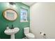 Stylish half-bathroom with a pedestal sink, unique mirror, and decorative accents at 20087 E Dartmouth Dr, Aurora, CO 80013