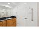 Bathroom with black countertops and wooden cabinetry, accompanied by a mirror, and essential fixtures at 20087 E Dartmouth Dr, Aurora, CO 80013