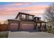 Inviting two-story home featuring a brick facade and a spacious three-car garage at 20087 E Dartmouth Dr, Aurora, CO 80013