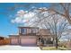 Charming two-story home boasts a three-car garage, covered porch, and manicured front yard at 20087 E Dartmouth Dr, Aurora, CO 80013