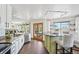 Bright kitchen with an island, stainless steel appliances, and access to an outdoor deck at 20087 E Dartmouth Dr, Aurora, CO 80013