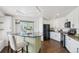Modern kitchen featuring white cabinets, dark countertops, and stainless steel appliances at 20087 E Dartmouth Dr, Aurora, CO 80013