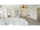 Sun-filled main bedroom showcasing neutral tones, stylish ceiling fan, carpet flooring, and bright windows at 20087 E Dartmouth Dr, Aurora, CO 80013