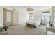Main bedroom with ceiling fan, bench, carpet, and bright windows at 20087 E Dartmouth Dr, Aurora, CO 80013