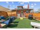 Beautiful backyard with turf, fence, barbecue, and outdoor games; perfect for entertaining at 2614 E 13Th Ave, Denver, CO 80206
