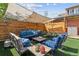 Relaxing backyard patio featuring comfortable lounge furniture, overhead shade, and stone-topped tables at 2614 E 13Th Ave, Denver, CO 80206