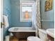 Charming bathroom features clawfoot tub, vintage-style fixtures, and a window for natural light at 2614 E 13Th Ave, Denver, CO 80206