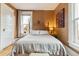 Bedroom featuring a queen sized bed, decorative painting, and a window with natural light at 2614 E 13Th Ave, Denver, CO 80206