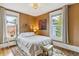 Bedroom features a queen sized bed, decorative painting, and dual windows with natural light at 2614 E 13Th Ave, Denver, CO 80206