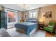 Cozy bedroom featuring bright windows, blue and white bedding and unique furnishings plus decorative art at 2614 E 13Th Ave, Denver, CO 80206