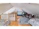 Bright attic bedroom featuring hardwood floors, comfortable beds, and a cozy seating area at 2614 E 13Th Ave, Denver, CO 80206