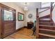 Inviting foyer featuring hardwood floors, staircase, and vintage accents at 2614 E 13Th Ave, Denver, CO 80206