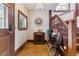Elegant foyer with hardwood floors, vintage furniture, and a decorative staircase at 2614 E 13Th Ave, Denver, CO 80206