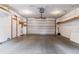 Spacious garage with concrete flooring, overhead lighting, storage shelves and doors at 2614 E 13Th Ave, Denver, CO 80206