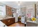 Functional kitchen featuring exposed brick wall, wood floors, and cozy dining space at 2614 E 13Th Ave, Denver, CO 80206