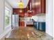 Functional kitchen featuring modern appliances, granite countertops, and ample cabinet space at 2614 E 13Th Ave, Denver, CO 80206