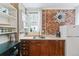 Efficient kitchen with brick accent wall, modern appliances, and ample counter space at 2614 E 13Th Ave, Denver, CO 80206