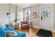 Cozy living room features hardwood floors, a window for natural light, and comfortable seating at 2614 E 13Th Ave, Denver, CO 80206