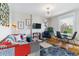Bright living room featuring eclectic furnishings, hardwood floors, and a large window at 2614 E 13Th Ave, Denver, CO 80206
