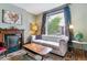 Bright living room with large windows, plush seating, vintage fireplace, and decor at 2614 E 13Th Ave, Denver, CO 80206