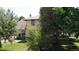 Backyard featuring mature trees, a patio and lush grass at 3330 Bruce Randolph Ave, Denver, CO 80205