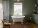 Charming bathroom featuring a freestanding tub, decorative rug and marble shower at 3330 Bruce Randolph Ave, Denver, CO 80205
