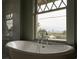 Bathroom with soaking tub, large picture window overlooking cityscape at 3330 Bruce Randolph Ave, Denver, CO 80205