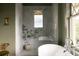 Bathroom featuring a glass enclosed shower and soaking tub by large window at 3330 Bruce Randolph Ave, Denver, CO 80205