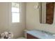 Charming bathroom featuring a marble countertop sink, modern fixtures, and a window providing natural light at 3330 Bruce Randolph Ave, Denver, CO 80205