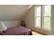 Bedroom with large windows, hardwood floors, chair, and plum-colored bedspread at 3330 Bruce Randolph Ave, Denver, CO 80205