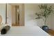 Bright bedroom with natural wood floors and white walls, and a view into the hallway at 3330 Bruce Randolph Ave, Denver, CO 80205