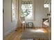 Bedroom with hardwood floors, two windows and accent chair at 3330 Bruce Randolph Ave, Denver, CO 80205