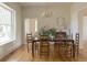 Dining room with a large window, a fireplace, hardwood floors, and a stylish chandelier at 3330 Bruce Randolph Ave, Denver, CO 80205