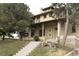 Impressive exterior with light-colored brick, large windows, a covered porch, and landscaped front yard at 3330 Bruce Randolph Ave, Denver, CO 80205