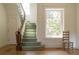 Elegant foyer with curved staircase, diamond-patterned window, and hardwood floors at 3330 Bruce Randolph Ave, Denver, CO 80205