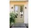 Elegant double front door with glass panels, flanked by stylish sconces and complemented by lush greenery at 3330 Bruce Randolph Ave, Denver, CO 80205