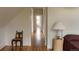 Hallway with hardwood floors, chair, and view into bedroom at 3330 Bruce Randolph Ave, Denver, CO 80205