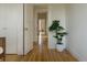 Bright hallway with hardwood floors, closet, doorway, and a large plant at 3330 Bruce Randolph Ave, Denver, CO 80205