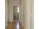 Hallway with hardwood floors leads to a bathroom with flowers and a window at 3330 Bruce Randolph Ave, Denver, CO 80205