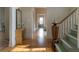 Hallway featuring original hardwood floors, a decorative table, and a view of the staircase at 3330 Bruce Randolph Ave, Denver, CO 80205