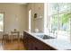 Bright kitchen features a large window, marble counters, and stainless faucet at 3330 Bruce Randolph Ave, Denver, CO 80205