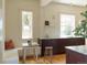 Eat-in kitchen features a window, custom cabinets, and marble countertops at 3330 Bruce Randolph Ave, Denver, CO 80205